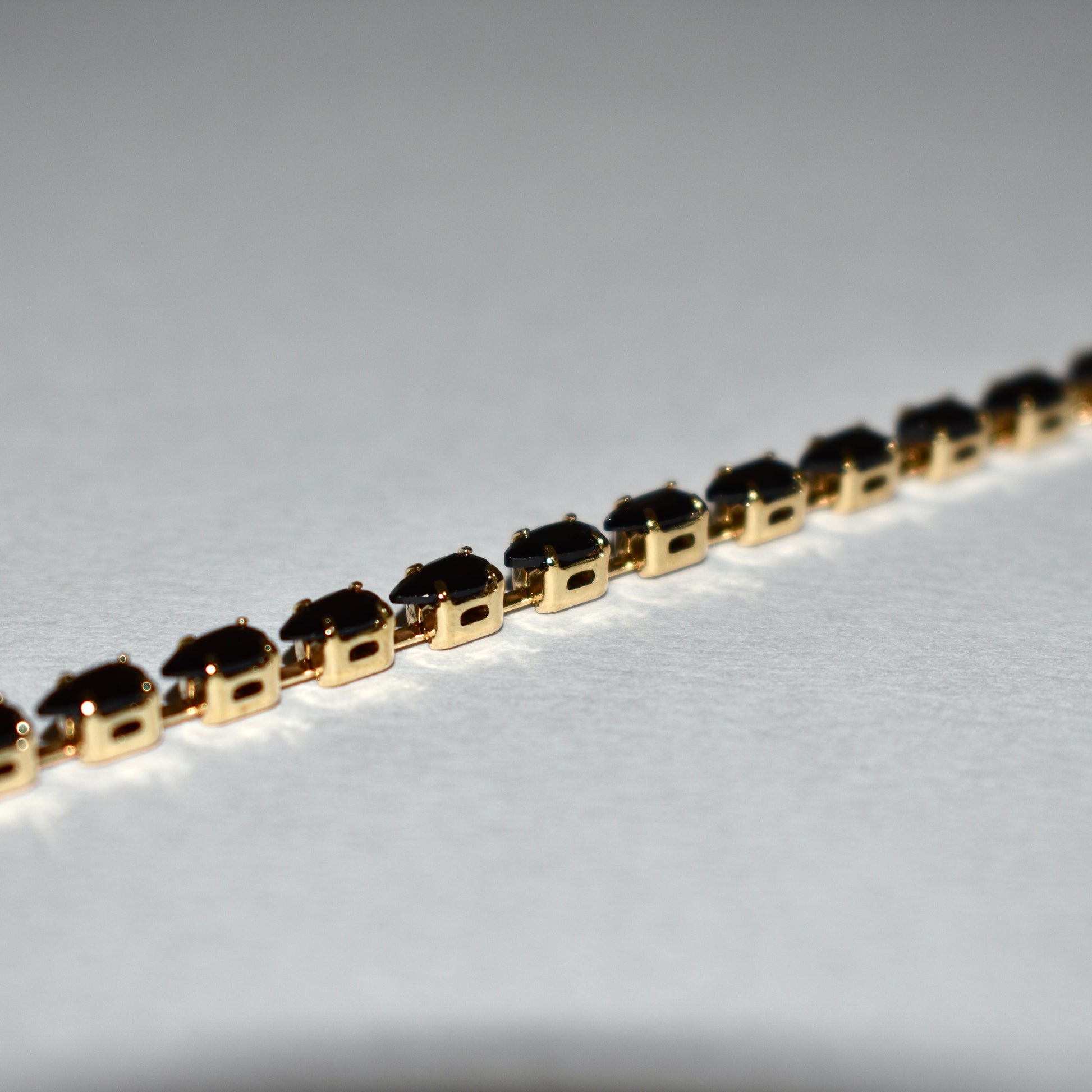 Classic Tennis Bracelet – Gold & Black Elegance