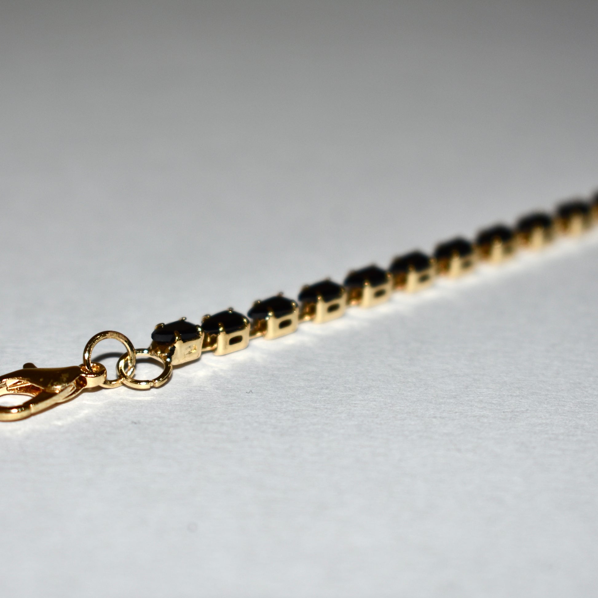 Classic Tennis Bracelet – Gold & Black Elegance